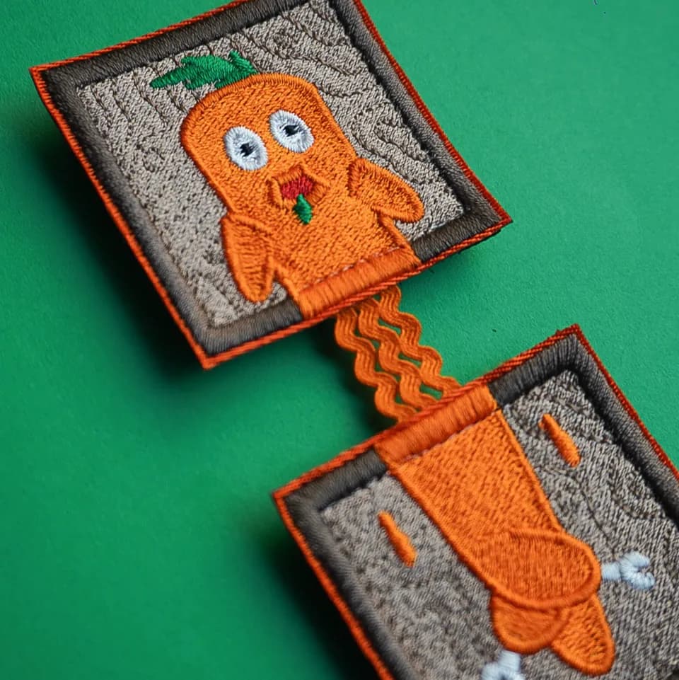 Gray patches embroidered with orange cartoon characters and borders