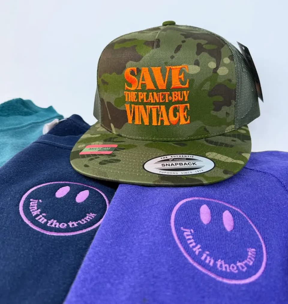 A camouflage cap embroidered with Save the Planet Buy Vintage lettering